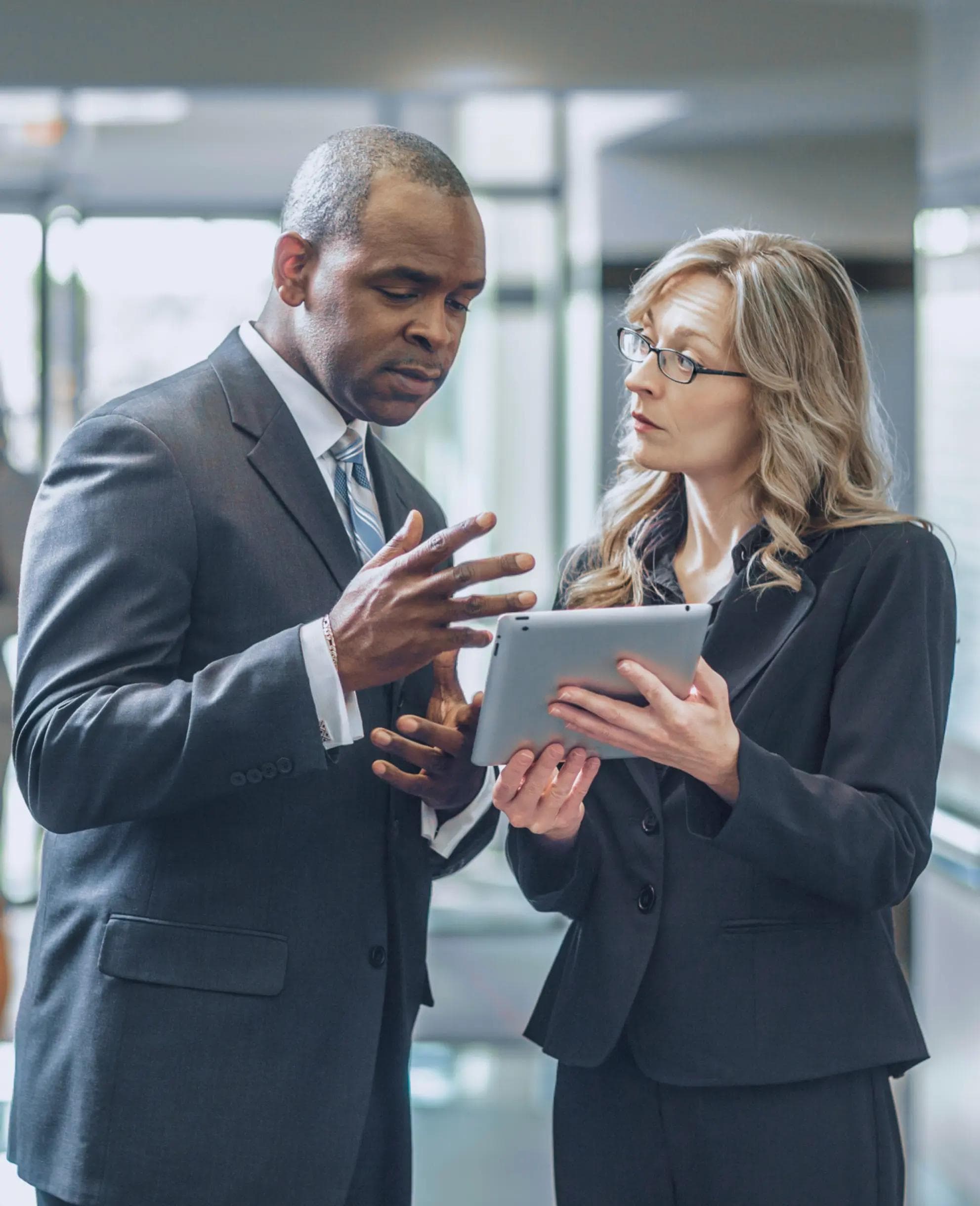 Image of two people reviewing a tablet.